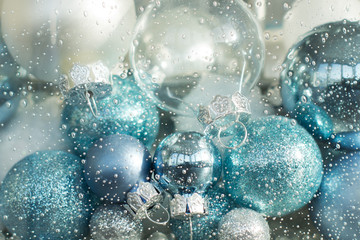 blue, turquoise and white christmas balls in a decorative glass