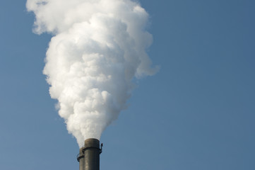 smoke pipe of a heat and power plant against blue sky