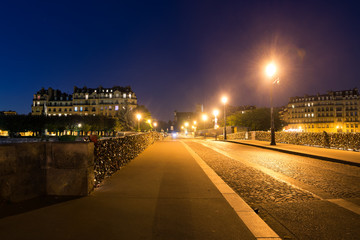 "Pont de la Tournelle" bridge at night in Paris, France