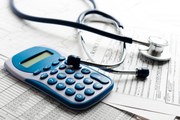 Health care costs. Stethoscope and calculator symbol for health