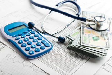Health insurance application form with banknote and stethoscope