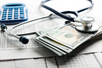 Health insurance application form with banknote and stethoscope