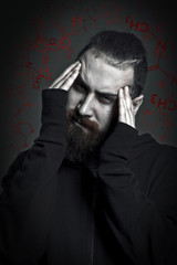 man with a beard is suffering from drug addiction