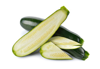 whole and portion cut fresh Zucchini on white background