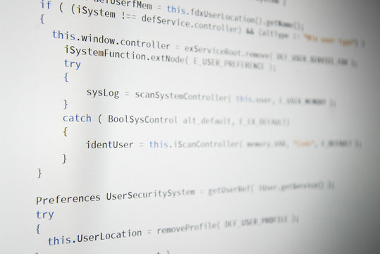 Software developer programming code. Abstract computer script code. Shallow depth of field, selective focus effect.