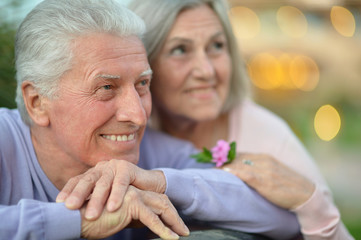smiling old couple with flower