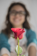 Hand holding red rose