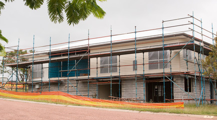 Building house with scaffolding for safety