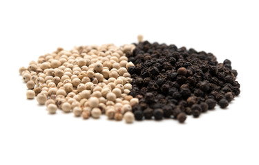 Pile of white and black pepper
