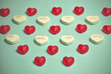 Valentine's Day Red Gummy and  Conversation Hearts on Blue Backg