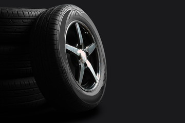 new tires are close to each other on an isolated dark background