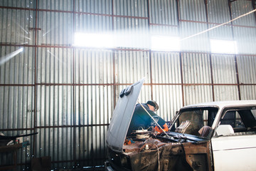 Mechanic repair and service car in garage