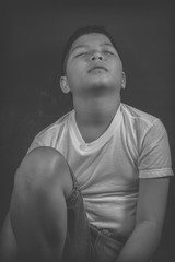 scared and alone, young Asian child who is at high risk of being bullied, trafficked and abused