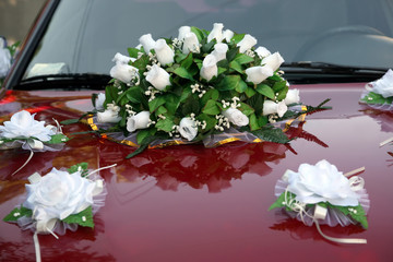 beautiful bouquet of ornamental flowers on the hood of the car