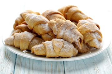 Fresh homemade croissants on a blue wooden table