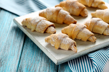 Fresh homemade croissants on a blue wooden table