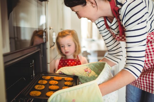 Mother and daughter baking cookies