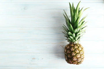 Fototapeta premium Ripe pineapple on a blue wooden table