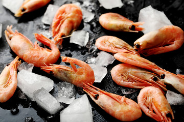 Fresh boiled shrimps on a black wooden table