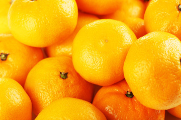 Orange and ripe mandarins background, close up