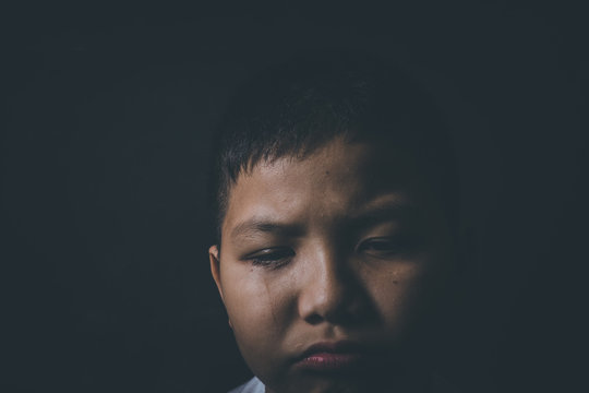 scared and alone, young Asian child who is at high risk of being bullied, trafficked and abused