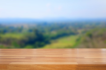 Empty wooden table and landscape background of forest and sky
