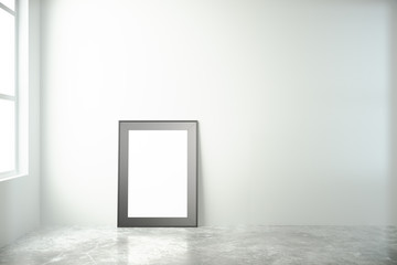 Blank picture frame in a white room with window and concrete flo