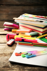 Bright school stationery on old wooden table