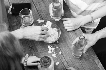 View on friends having alcoholic drinks in the bar, close-up