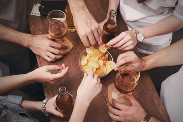 View on friends having alcoholic drinks in the bar, close-up
