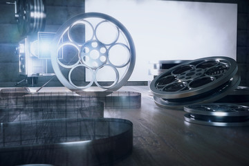 The tape of film and camera on the wooden table, backlit