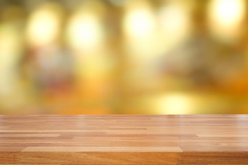 Empty wooden table and blurred cafe background