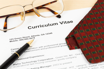 Curriculum vitae or CV with pen, glasses, and neck tie; CV and i