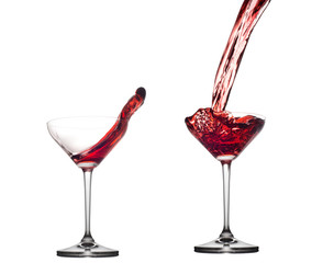 Red cocktail splashing from glass isolated on white background