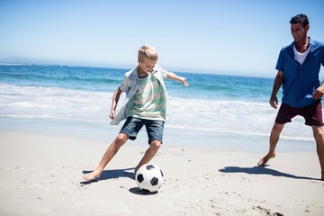 Father and son playing soccer