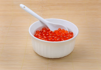 Bowl with caviar on bamboo mat