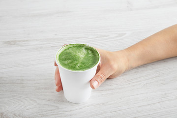 Woman takes away matcha latte