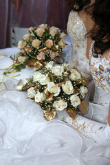 two brides holding wedding bouquet in hands