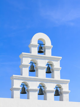 White bell tower santorini style with clear blue sky