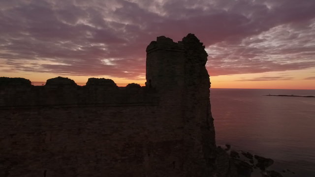 Stunning aerial shot Tantallon Castle off the coast of North Berick, Scotland with Bass rock in the background

