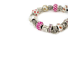 Modern fashion jewellery with charms and pendants, bracelet on white background