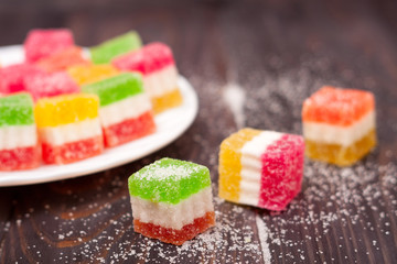 Jelly sweet, flavor fruit, candy dessert colorful on wood background.