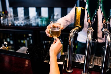 Barman giving drink to customer