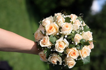 beautiful wedding bouquet of white roses in the bride's hand