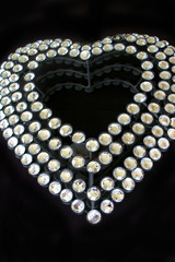 Diamante heart on black background