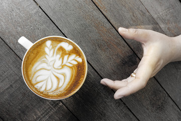 a cup of latte art coffee take with selective color technique and art lighting