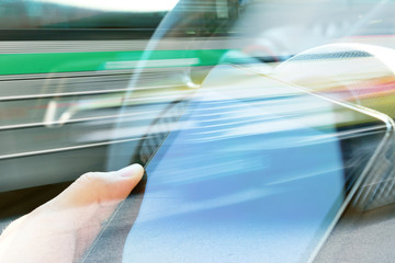 Business technology concept,business man Using digital tablet double exposure and blurred view of car on city street