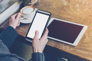 woman using smartphone in coffee shop with vintage tone.