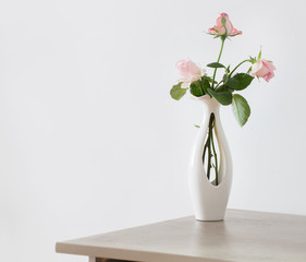 still life of pink rose in ceramic vase