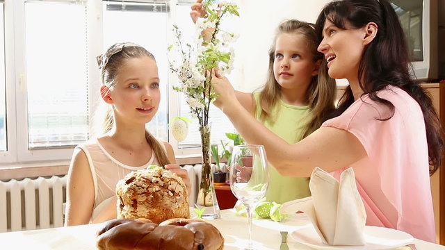 Happy family with children hang easter egg. Camera slowly moves toward.